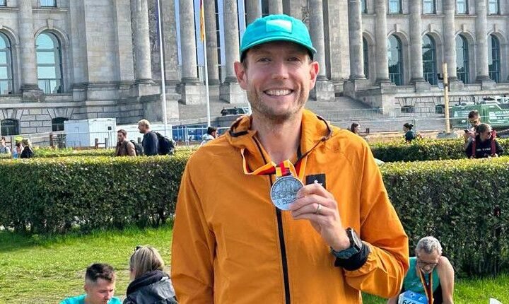 Nick Harris-Fry holding a Berlin Marathon finisher’s medal